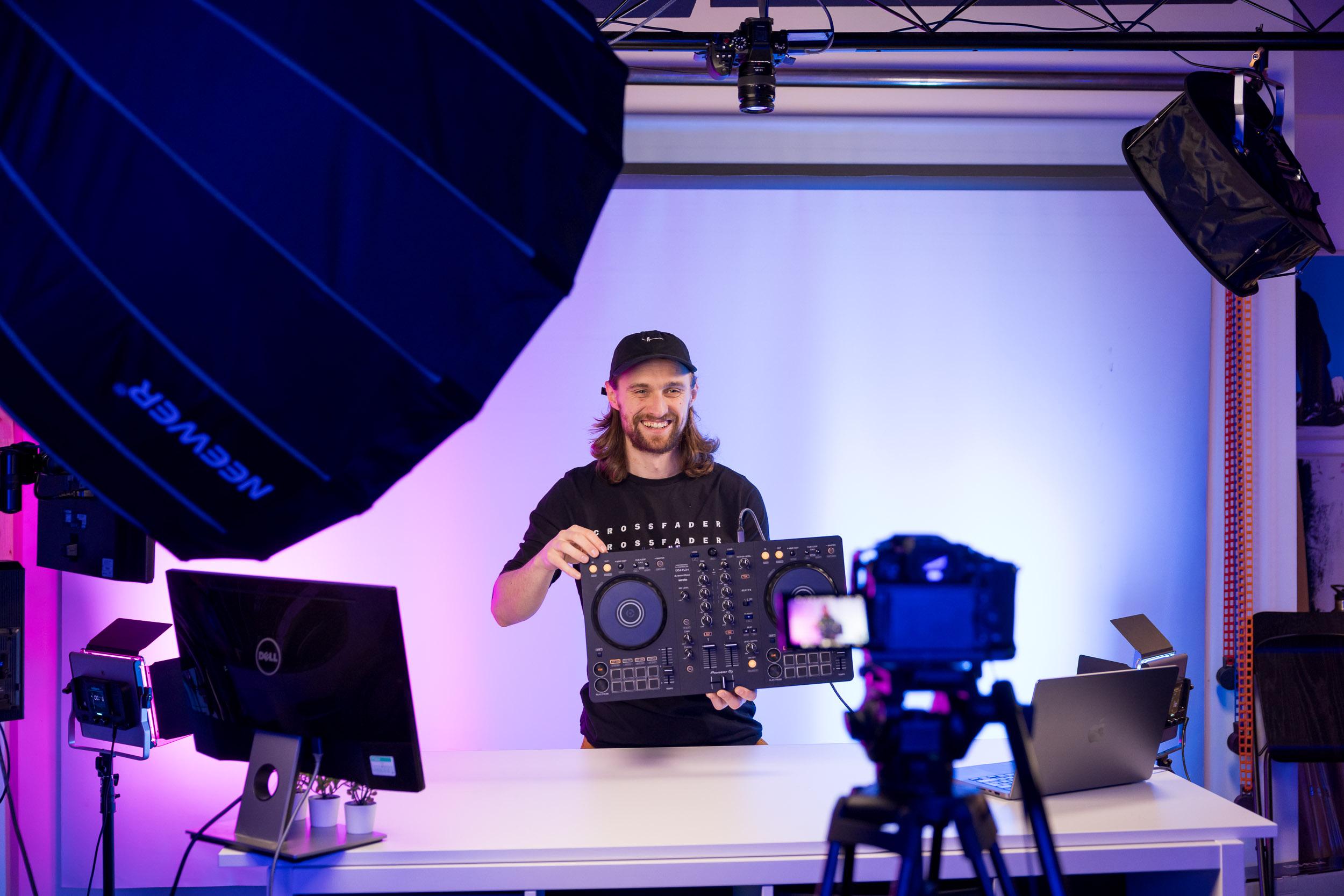 Crossfader DJ tutor presenting a lesson in the studio with full production lighting and cameras.
